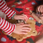 Child playing inside Christmas table playhouse – cozy under-table play space